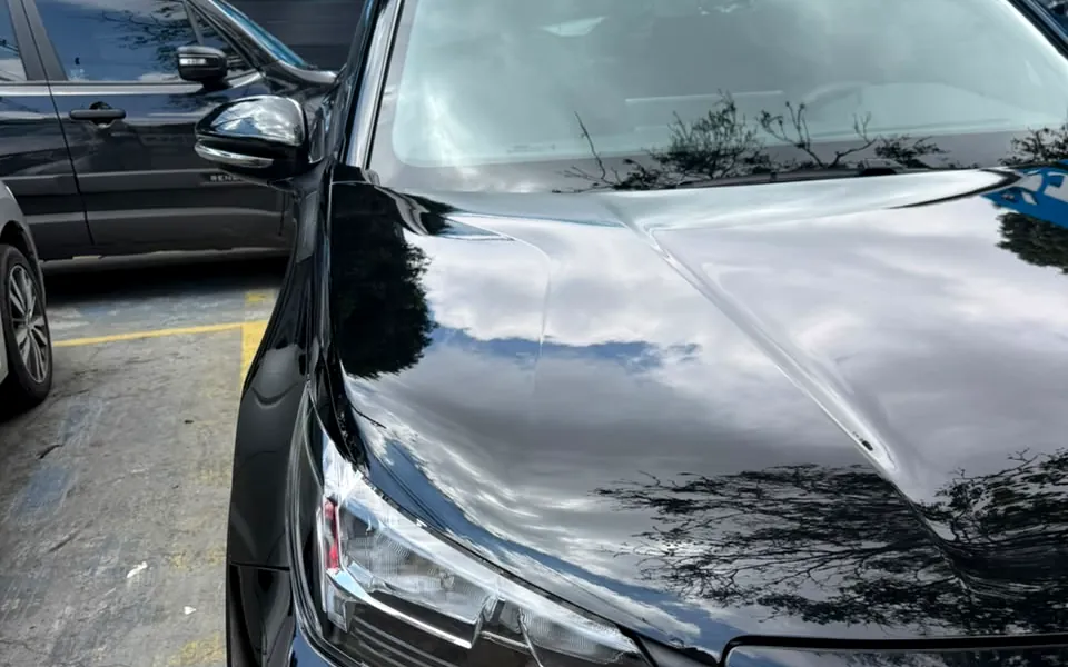 Carro preto com a pintura brilhante no pátio da Care Automotive